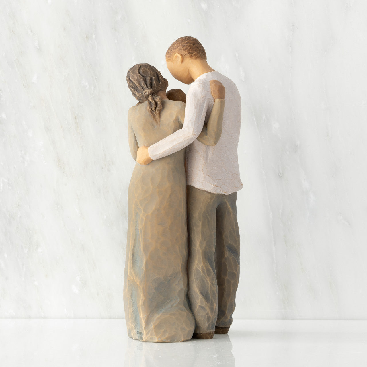 We are Three (woman: darker skin, man: lighter skin)